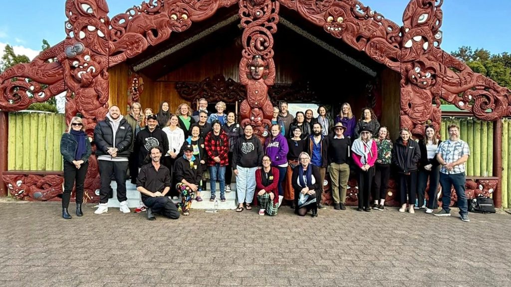 A group of people gathered outside Aratiatia Marae during the Aotearoa Food Rescue Alliance hui hosted by Go Eco in May 2025.